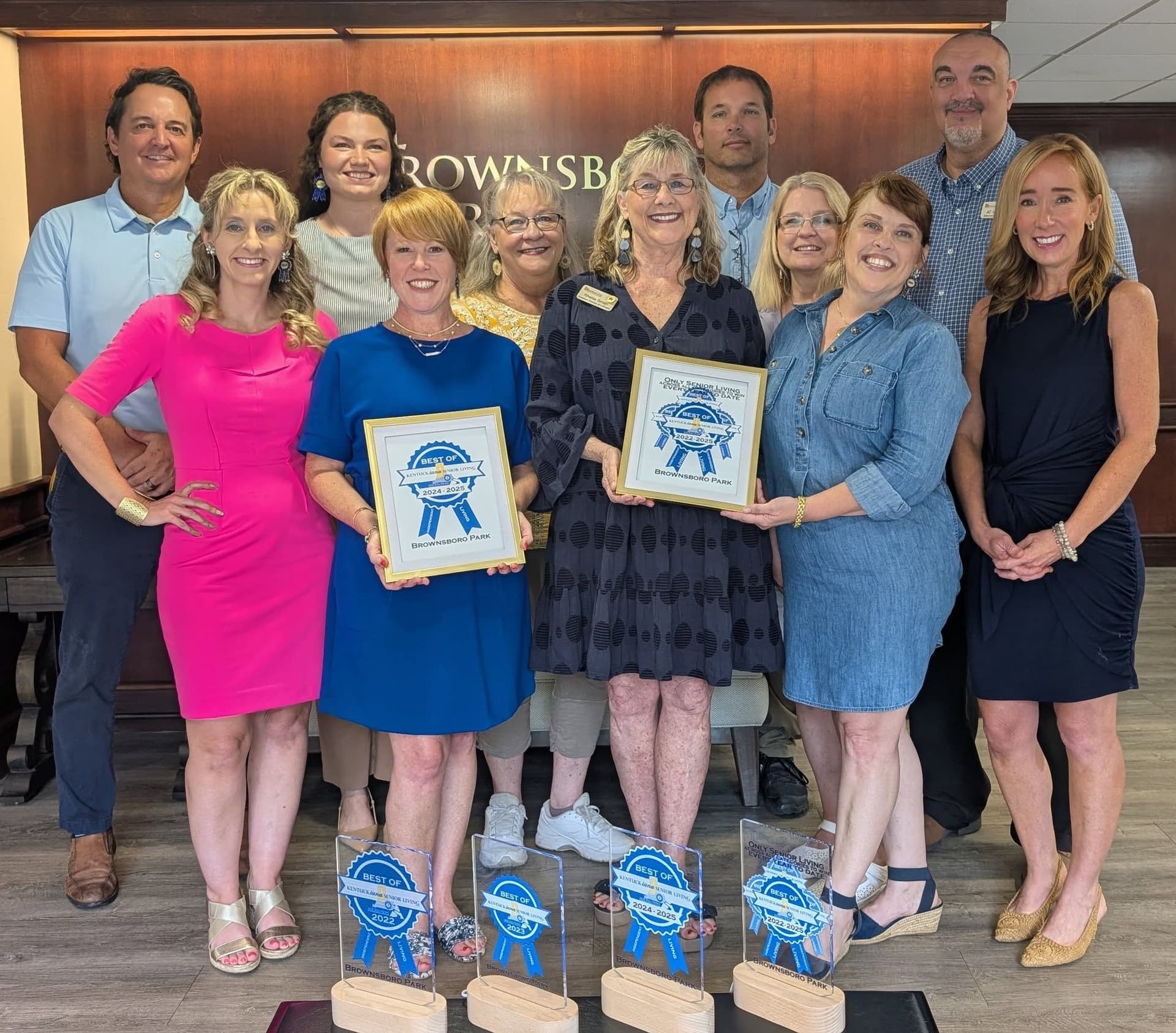 Staff holding Best of Kentuckiana Senior Living award plaques